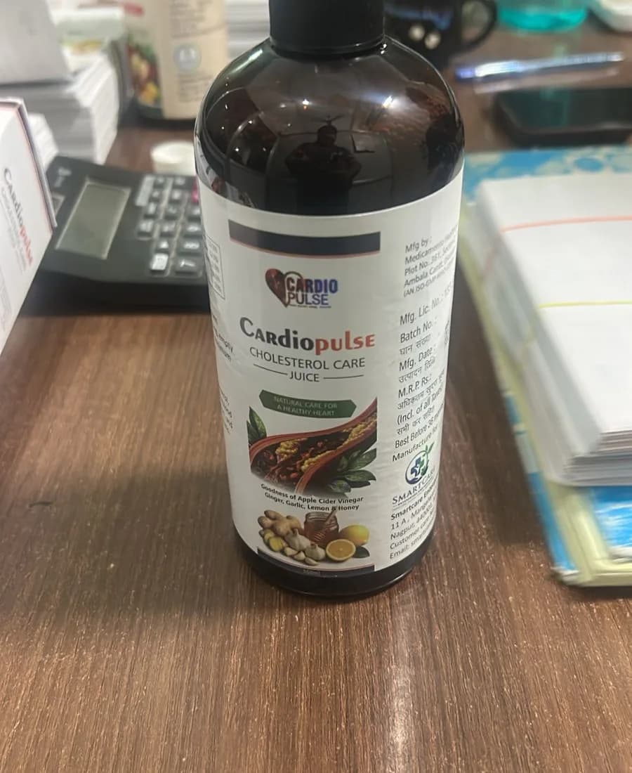 Cardiopulse Cholesterol Care Juice bottle on a wooden desk